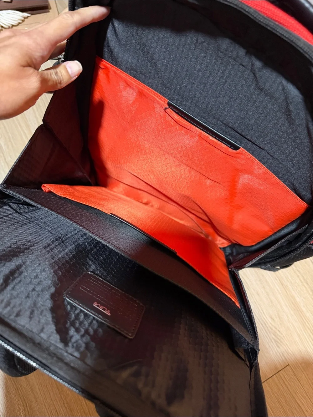 Tumi Red and Black Men/Women’s Backpack with Multiple Front Pockets